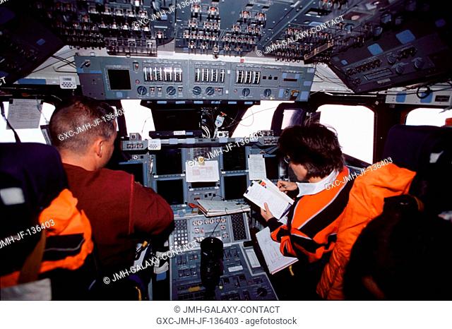 Astronauts Duane G. Carey (left) and Nancy J. Currie, STS-109 pilot and mission specialist, respectively, are photographed on the forward flight deck of the...