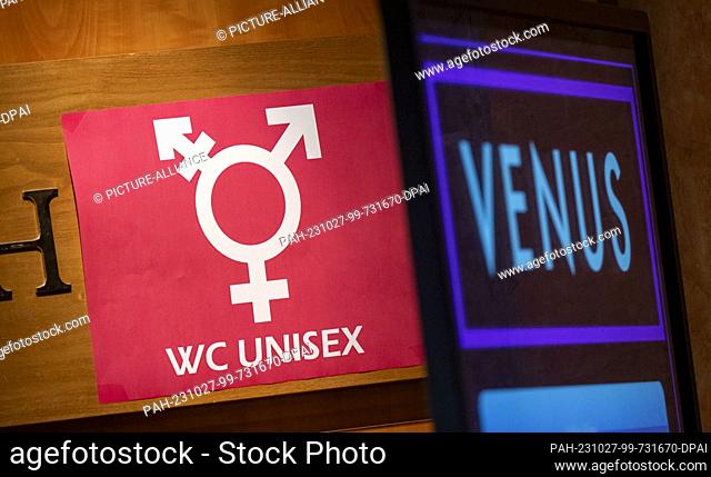27 October 2023, Berlin: A sign reading ""WC Unisex"" hangs at the entrance to a restroom at the Venus 2023 erotic trade show