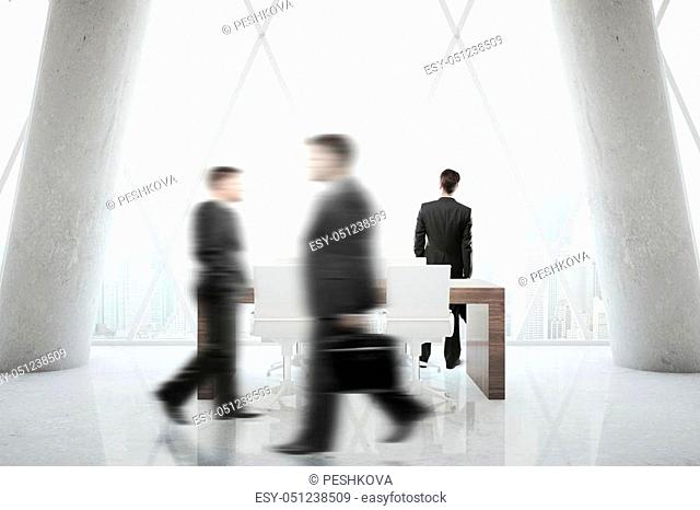 Blurry businesspeople walking in modern office