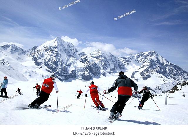 Group of Skiers on the slope, Ortler mountain range in the background, Sulden, Madritsch, South Tyrol, Italy