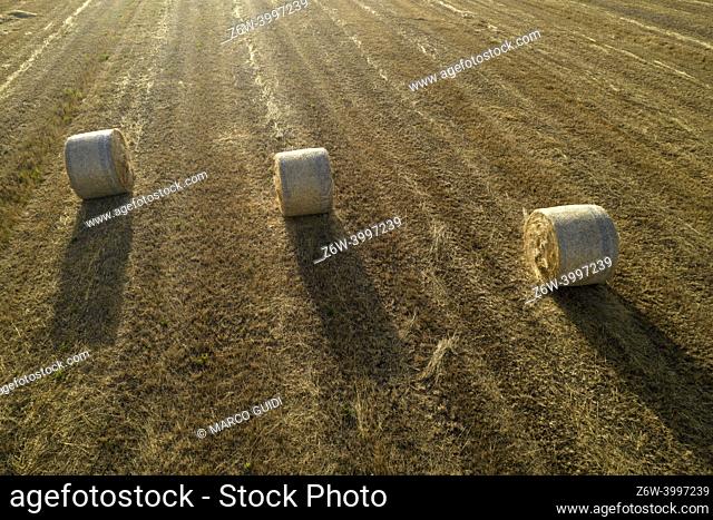 Aerial documentation of the classic straw balers in the fields in the summer season