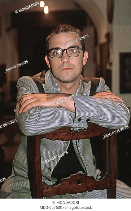 British singer Robbie Williams sitting on a chair at the music festival Vota la voce 1997. Arezzo, September 1997