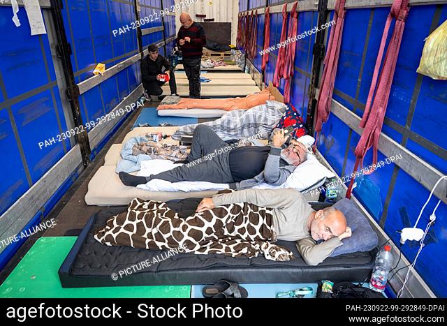 22 September 2023, Hesse, Gräfenhausen: Truckers from Georgia lie on a mattress camp in the back of a truck. Around 30 drivers have gone on hunger strike to...