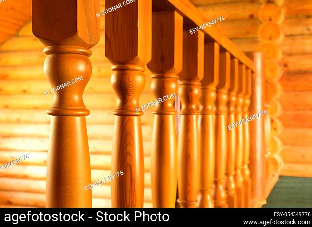 Close-up row of wooden column wooden stairs in russian wooden blockhouse