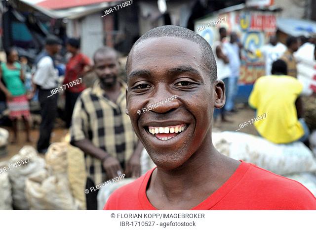 Smiling young man, portrait, urban market of Des Croix Bossales in the port district of La Saline, Port-au-Prince, Haiti, Caribbean, Central America