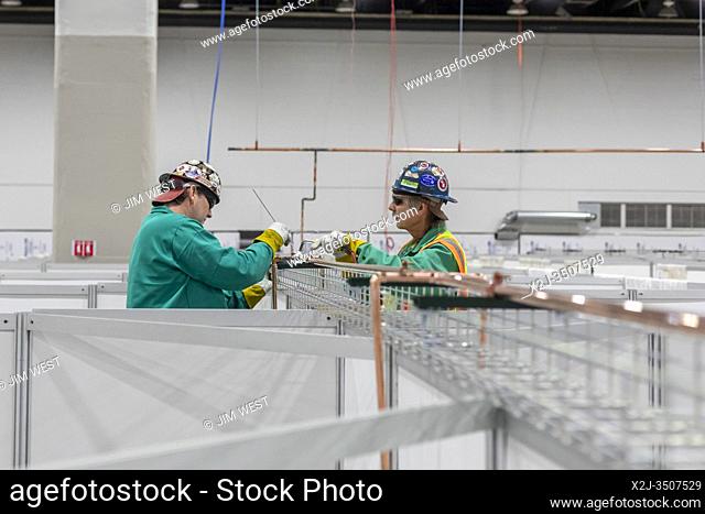 Detroit, Michigan USA - 6 April 2020 - Workers construct an emergency field hospital at the TCF convention center. The 1
