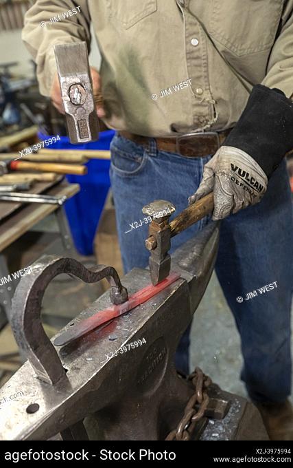 Colorado Springs, Colorado - Blacksmith Fred Martin creates garden tools from discarded firearms. Martin is part of a Mennonite nonprofit, RAWTools
