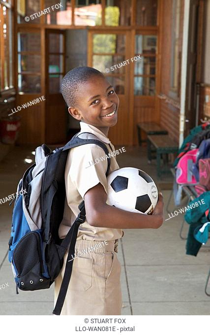 Portrait of a smiling schoolboy with his soccer ball, KwaZulu Natal Province, South Africa