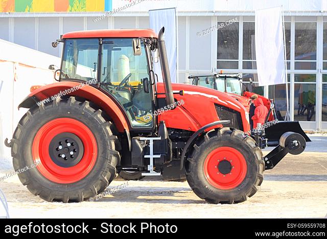 Agricultural machinery, tractor with the cultivator at the exhibition, agribusiness concept