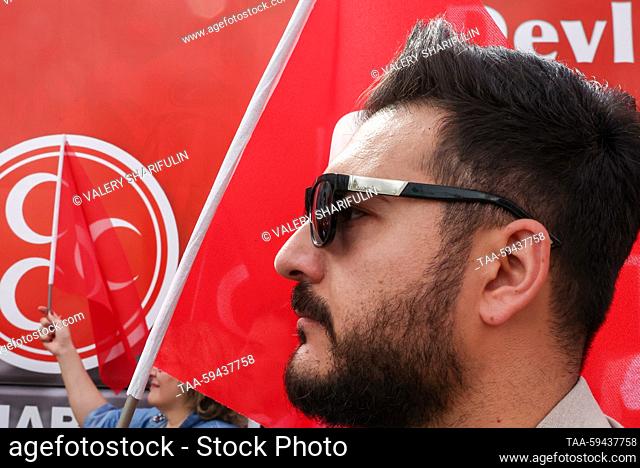 TURKEY, ANKARA - MAY 27, 2023: A man wearing sun glasses is seen during an election campaign rally of supporters of presidential candidate Recep Tayyip Erdogan