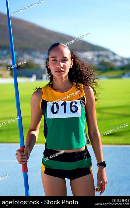 Portrait confident female track and field athlete with javelin