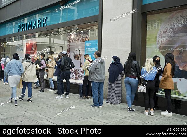 Shoppers in Oxford Street, in line to enter Primark store with signs advising to keep safe social distance due to Coronavirus / Covid-19 pandemic in London