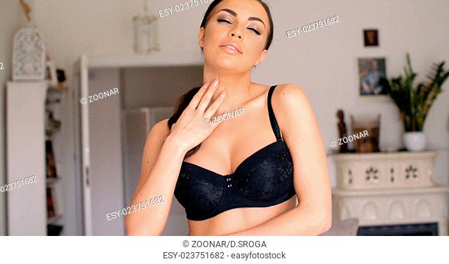 Woman Wearing Black Bra with Hand on her Lips
