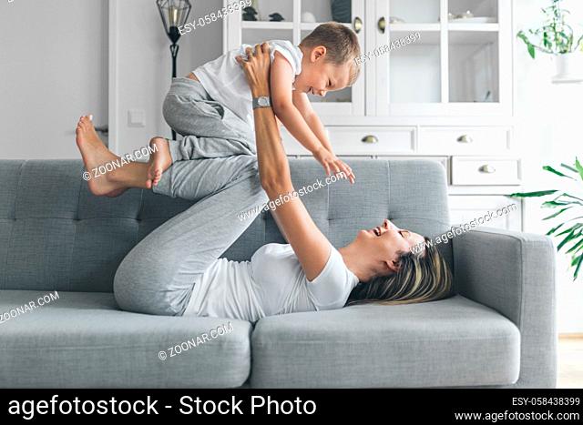 Mother with her son on a sofa in their living room