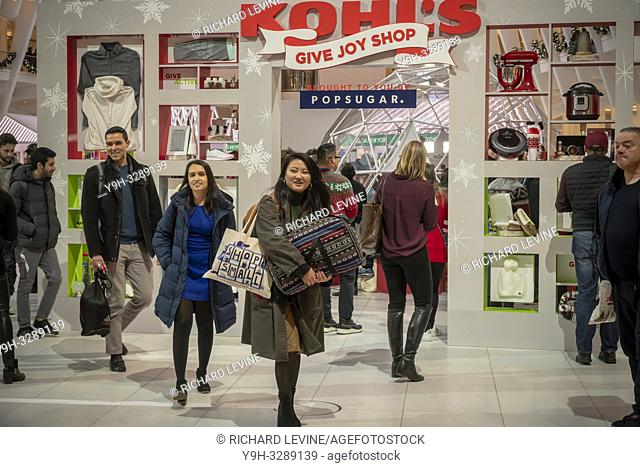 Visitors crowd the Kohl's "Give Joy Shop" pop-up branding event in the World Trade Center Oculus in New York on Thursday, December 6, 2018