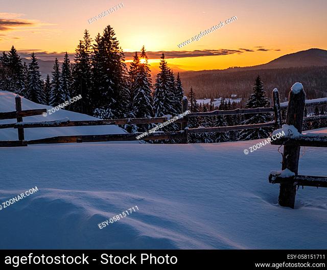Small and quiet alpine village outskirts and winter sunrise snowy mountains around, Voronenko, Carpathian, Ukraine