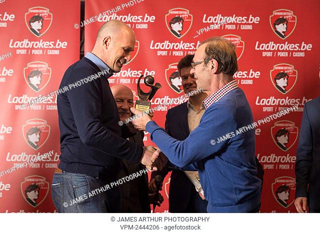 Club Brugge's head coach Philippe Clement (L) receives the trophy at the 9th edition of the Raymond Goethals award, for the coach whose style was the closest to...