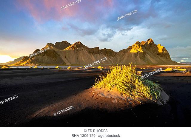 Dramatic light with view of the mountains of Vestrahorn from black volcanic sand beach at sunset, Stokksnes, South Iceland, Iceland, Polar Regions