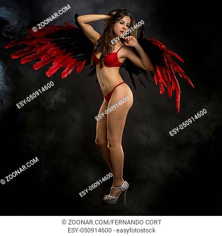 brunette girl in underwear with huge black and red bird wings