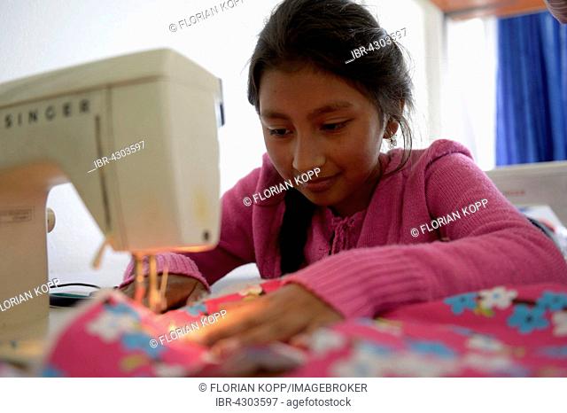 Girl using sewing machine, tailoring, vocational training, Creciendo Unidos social project, Javier Villa, Bogotá, Colombia