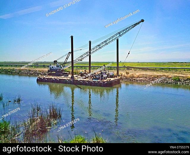 Construction crane on a barge in a canal near Stockton, California