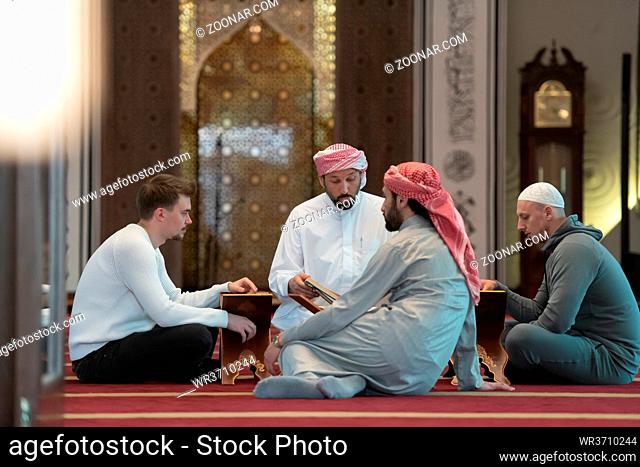 muslim people in mosque reading quran together concept of islamic education and school of holly book kuran