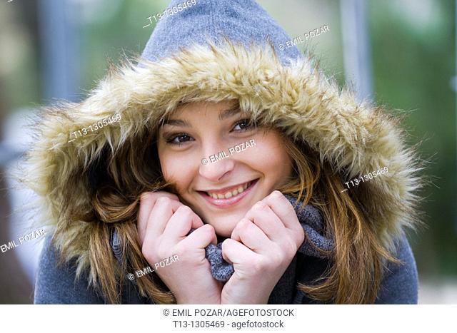 Happy teen girl warm under the hood