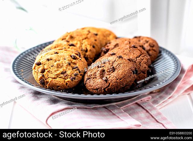Tasty biscuits with chocolate. Sweet chocolate cookies on plate
