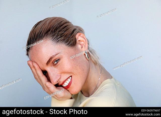 Portrait of a young happy woman smiling on white background, skin care and health. High quality photo