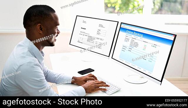 Business Manager Looking At Electronic Invoice Online
