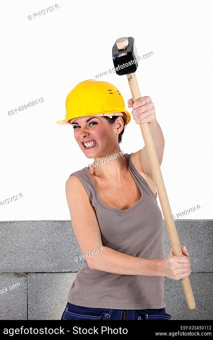 female bricklayer holding hammer