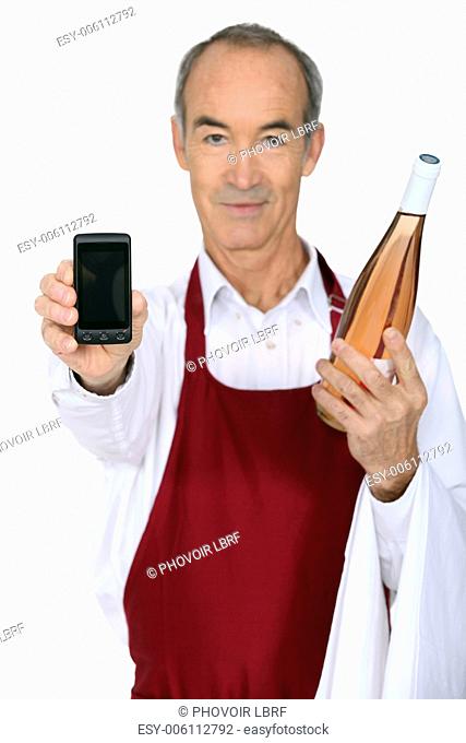 Man with a bottle of wine and a phone left blank for your message