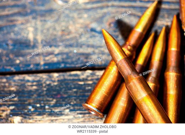 Still life with five rifle cartridges