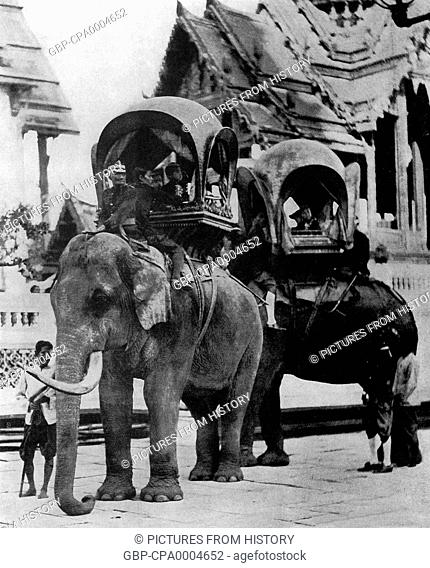 Thailand: Elephants caparisoned with howdahs carry the young princes in the courtyard of the Grand Palace in Bangkok, late-19th century