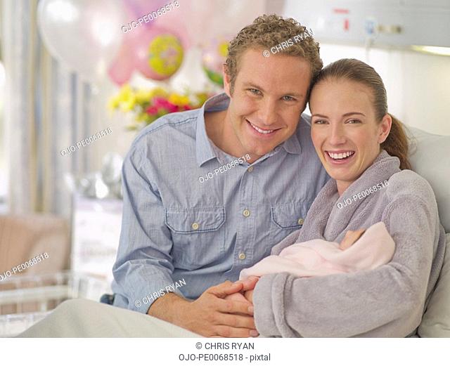 Couple holding newborn baby