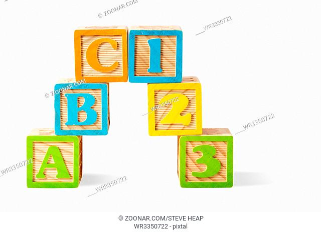 ABC and 123 Number wooden blocks stacked on white background and isolated with path