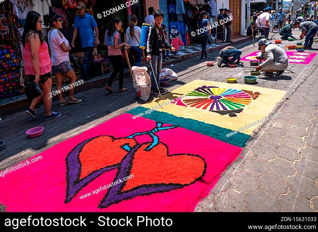 Santiago Atitlan, Guatemala - 30 March 2018: Local people making alfombra, colorful sawdust carpets with hearts for Semana Santa, Easter on the street