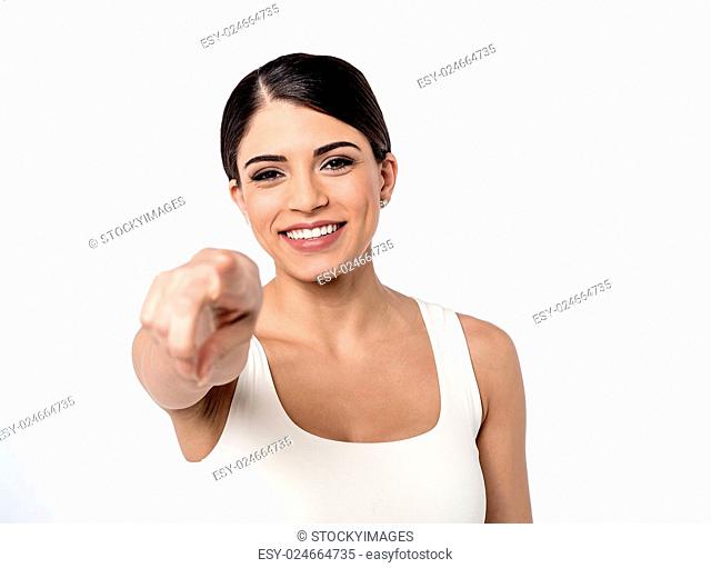 Smiling woman pointing her finger outwards