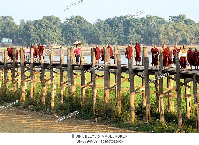 Locals and monks on a teak bridge, U Bein Bridge, over Thaungthaman Lake, Amarapura, Mandalay Division, Myanmar