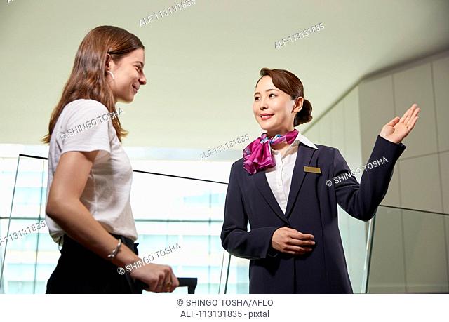Japanese Flight Attendant helping customer