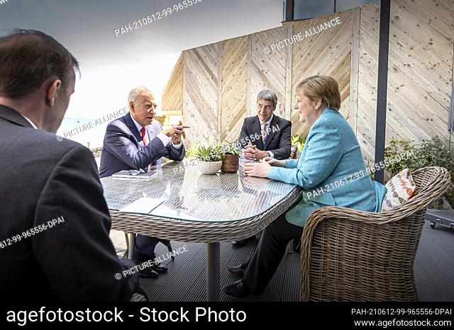 HANDOUT - 12 June 2021, United Kingdom, St.Ives: German Chancellor Angela Merkel (CDU) and US President Joe Biden (2nd from left) sit with their foreign policy...