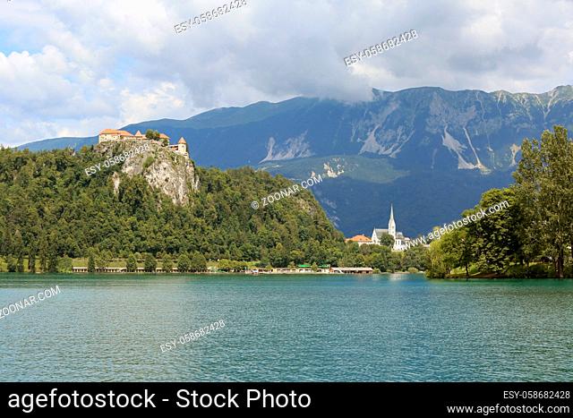 Lake Bled Slovenia. Beautiful mountain lake in summer with small Church on an island with castle on cliff and european alps in the background