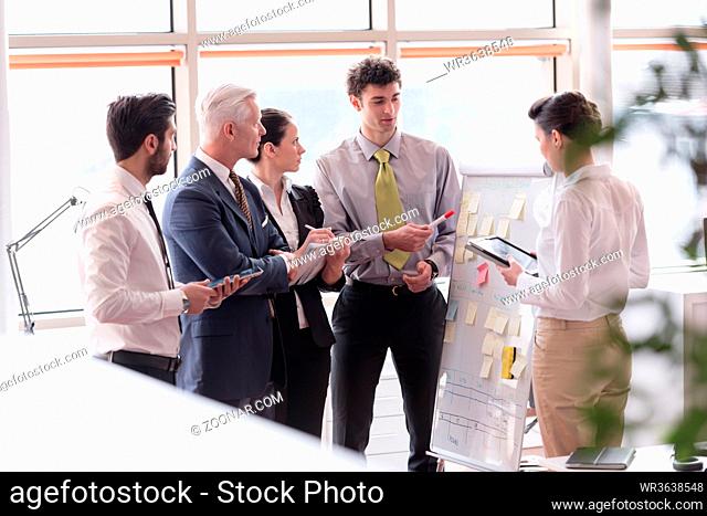 young startup businessman making presentation of project to senior investior, group of business people taking notes and make plans on white flip board and...