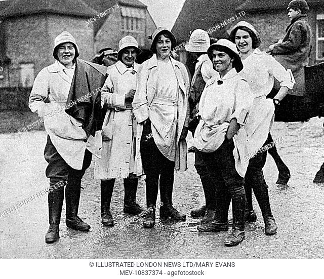 A group of cheery land girls taking a break from work on a Surrey farm in 1917. The Bystander magazine, in which this photograph was published, comments