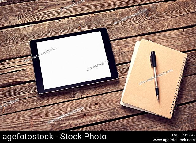 Tablet and notepad on desktop. Clipping path included