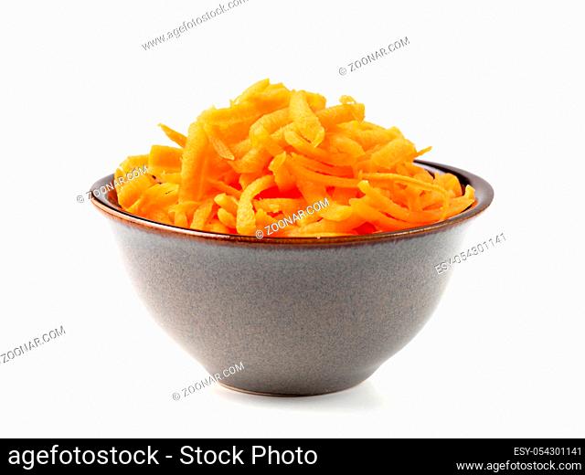 Fresh organic shredded carrots in small white bowl. Raw grated carrots isolated on white with clipping path