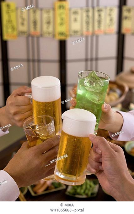 Four People Toasting with Beer and Chu-Hi at Izakaya