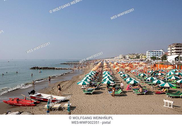 Italy, Province of Venice, Caorle, View of beach with sunsahdes