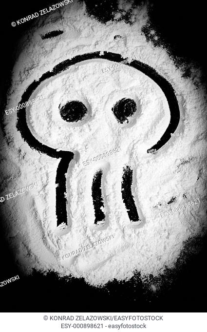 Skull shape drawed on white powder similar to cocaine