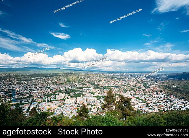 Tbilisi, Georgia. The Aerial Panoramic View Of Georgian Capital. Cityscape In Summer Sunny Day Under Blue Cloudy Sky